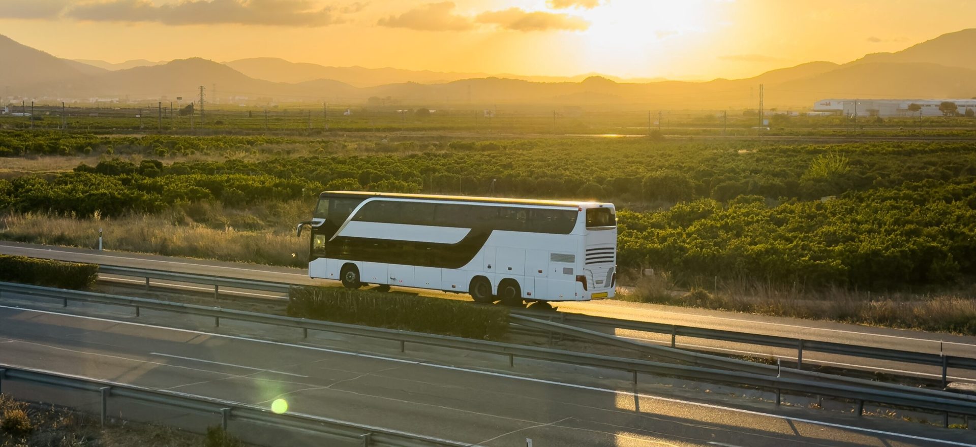 Bus,On,Highway,On,Sunset.,Tour,Bus,Driving,On,Highway
